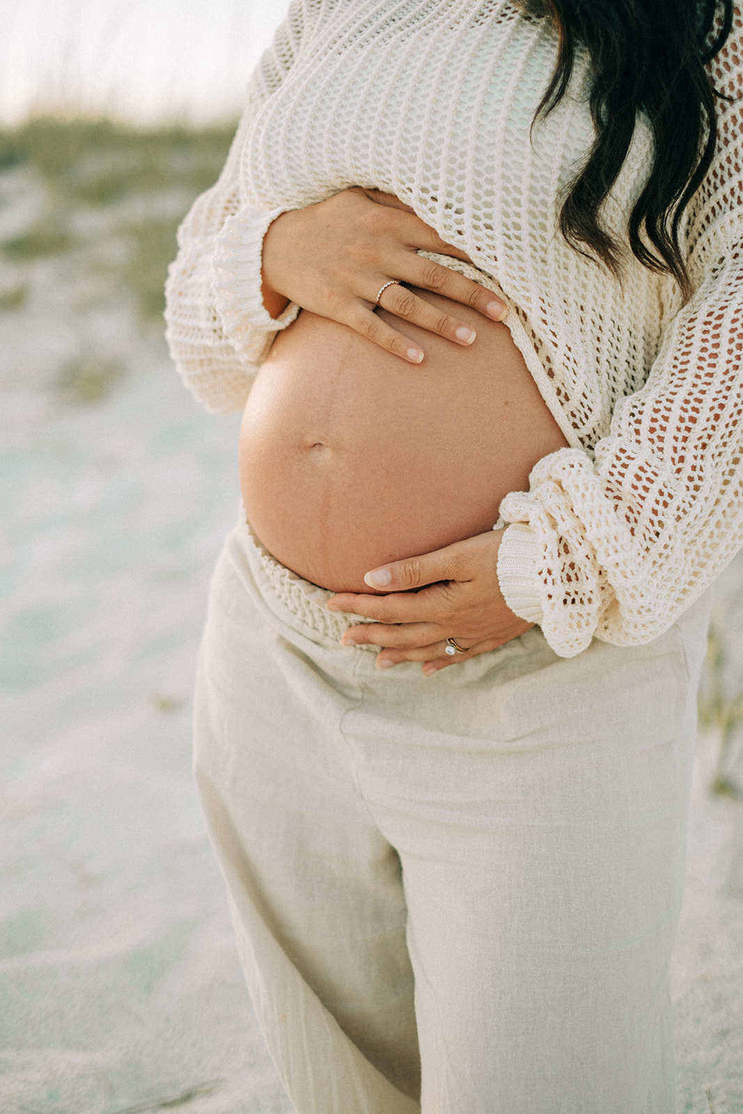 Hands resting tenderly on a belly